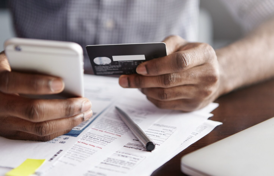 Reviewing credit card statement while checking how long negative marks stay on credit report