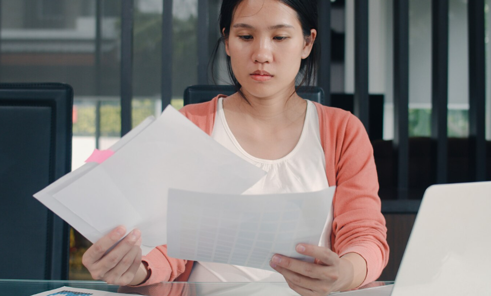 Reviewing financial documents while learning how to remove late payments from credit report