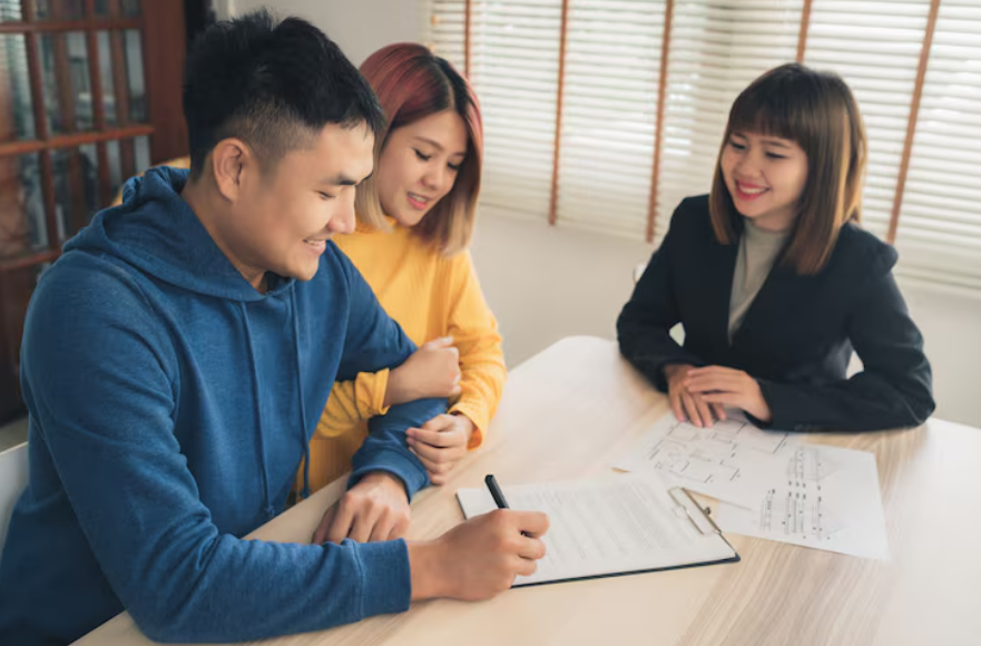 Couple reviewing paperwork while deciding should you co-sign a loan